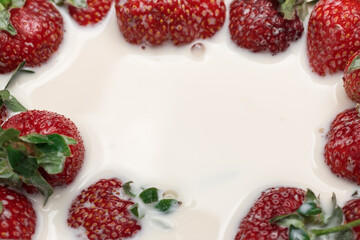 Red and ripe strawberries in white cream.