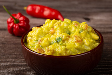 Bowl with guacamole on the table.