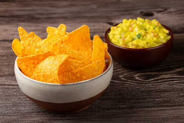 Nachos with guacamole on the table.