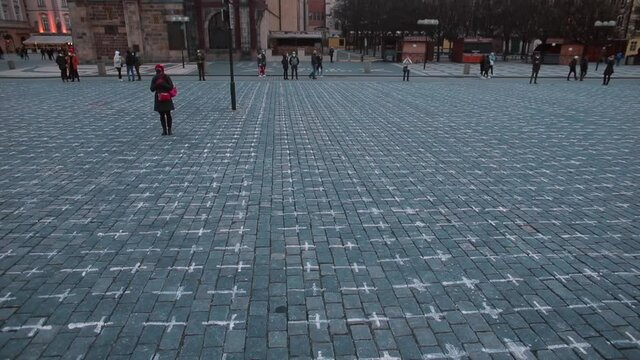Square in Prague with painted crosses on the sidewalk. A symbol of memory for those who died from coronavirus in the Czech Republic.