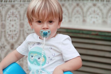 Portrait of a boy with a dummy in his mouth