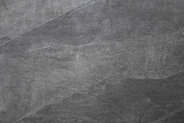 Fototapeta premium Dark grey stone wall texture . Gray rough backdrop. Stucco surface. Abstract pattern. Texture of natural granite. Abstract art creative background.