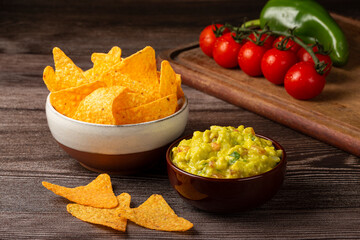 Nachos with guacamole on the table.