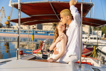 Obraz na płótnie Canvas couple sitting on a yacht in the early morning