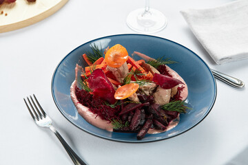 Hummus with vegetables, beetroot hummus with sauteed vegetable sticks and svela leaves, light background.