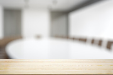 Empty office wooden table with empty space on modern conference room background, closeup, mock up