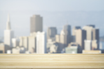 Empty tabletop made of wooden dies with blurry city view in sunny weather on background, template