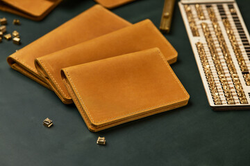 Set of handmade leather goods, key holder rings, wallet, purse, notepad, handbook. Handcrafted leather goods, close-up