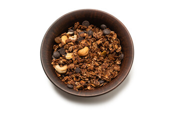 Chocolate granola cereal with nuts in a bowl background.