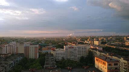 Evening sunlight falls on a large industrial city. Panorama