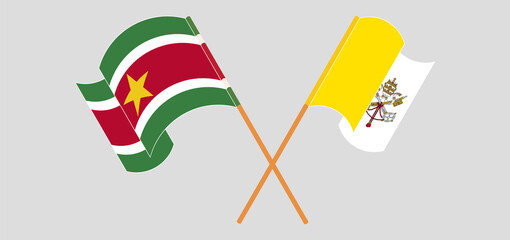 Crossed and waving flags of Suriname and Vatican