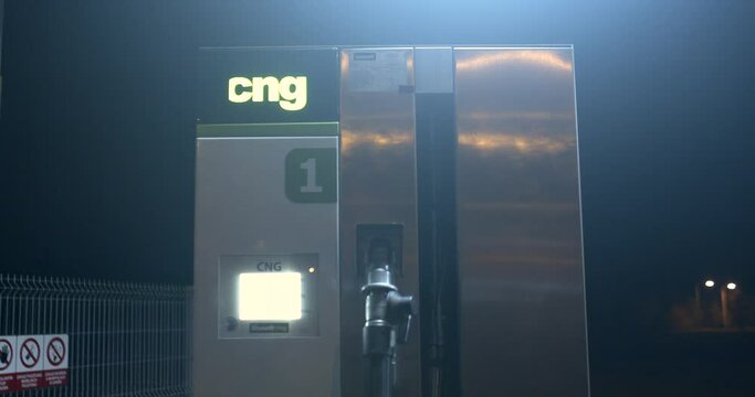 Refueling terminal CNG symbol at gas station night. Attracting the attention of the buyer. gas designation. Dark background Column number.