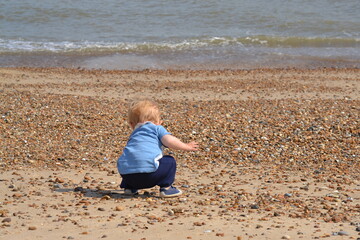 little child playing on the beach