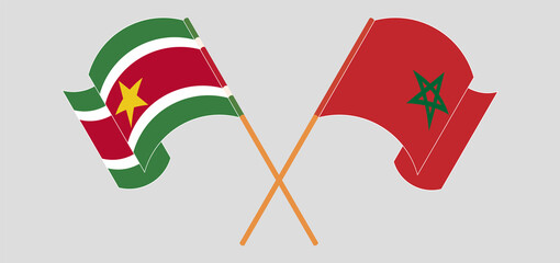 Crossed and waving flags of Suriname and Morocco