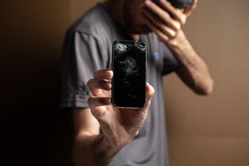 man showing broken phone screen