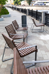 Single benches in the city. Bank of the river.