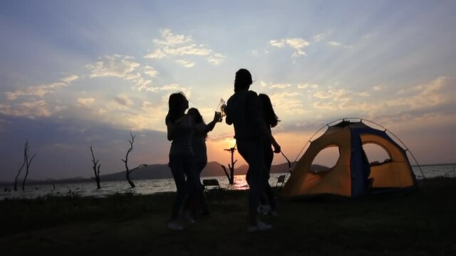 Happy and Funny Teenage tourist dring and dance at front of camping tent during set set