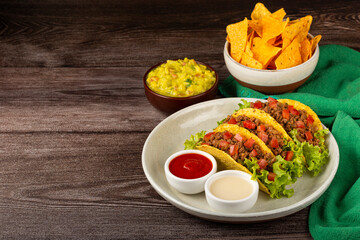 Mexican tacos with lettuce, beef and tomatoes.