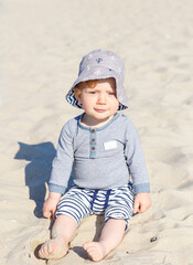 portrait of a boy in a panama hat on the beach. eight month old blonde