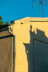 Shadow of one house on the wall of another.