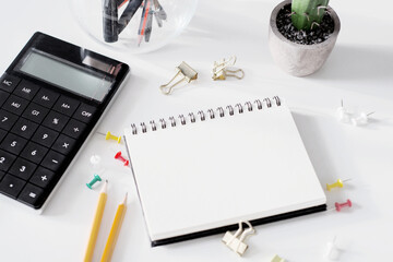 Office tools with blank notebook on white table