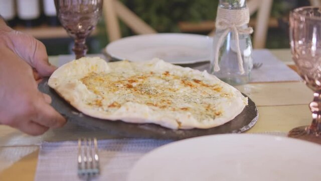 Baking Manakish. Lebanese Food:   A cook preparing zaatar pizza 