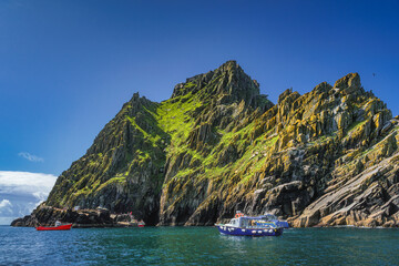 Cruise boats with tourists docking to Skellig Michael island, where Star Wars were filmed, UNESCO...