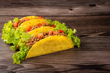 Mexican tacos with lettuce, beef and tomatoes.