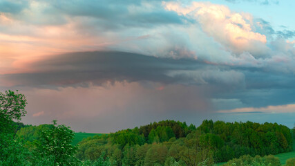 The sky before the rainstorm. Real rain from the clouds. Picturesque cyclone storm clouds before rain and thunder. Atmospheric cloudscape. Weather forecast by meteorological observations.