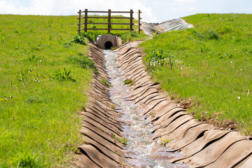Man made storm drain in a field