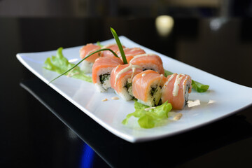 Sushi rolls on white dish. Japanese food.