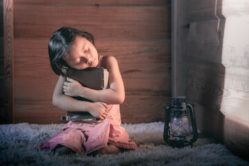 Little girl holding Bible and praying in morning, Prayer concept for faith.