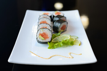 Sushi rolls on white dish. Japanese food.