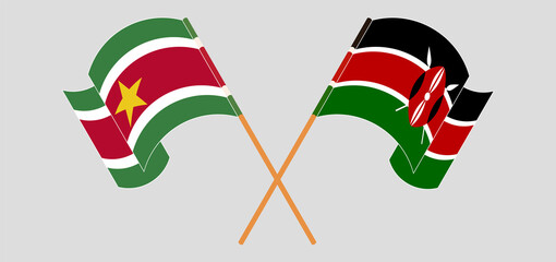 Crossed and waving flags of Suriname and Kenya