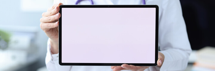 Female doctor therapist holding digital tablet closeup