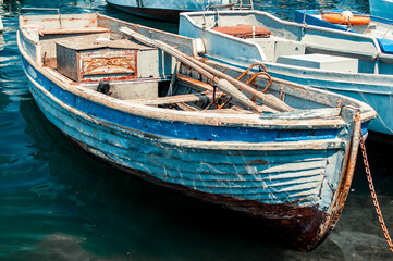 Fototapeta na wymiar Old wooden boat in Venice, Italy on the water near the sea pier
