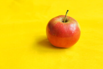 pple ripe red isolated, close-up, on a yellow background with a place for the inscription. High quality photo