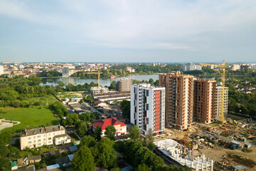 Fototapeta na wymiar Aerial view of tall residential apartment buildings under construction. Real estate development.