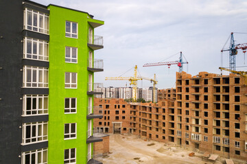 Aerial view of city residential area with high apartment buildings under construction.