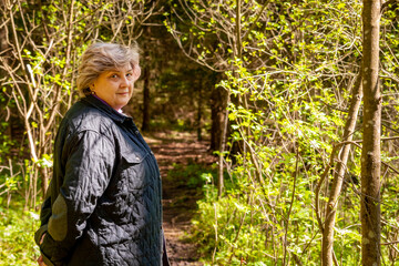 The cheerful mature woman smiled at the photographer.