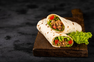 Mexican burritos stuffed with beef and salad. - obrazy, fototapety, plakaty