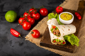 Mexican burritos stuffed with beef and salad.