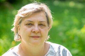 The cheerful mature woman smiled at the photographer.