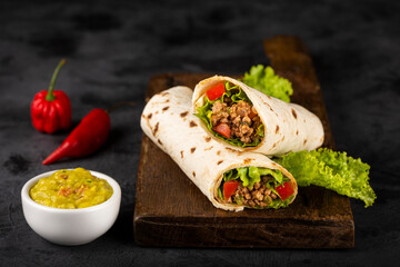 Mexican burritos stuffed with beef and salad.