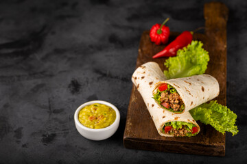 Mexican burritos stuffed with beef and salad.