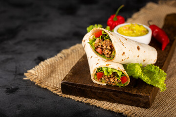 Mexican burritos stuffed with beef and salad.