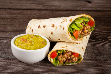 Mexican burritos stuffed with beef and salad.