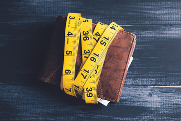 measuring tape and wallet on the table
