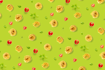 background from Italian tagliatelle pasta. raw pasta fettuccine, pop art background, flat lay. Italian raw nest pasta isolated on green. not seamless pattern