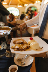 mexican dessert Cajeta crepes with vanilla ice cream close up caramel sauce